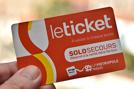A person holds a ticket purchased on a bus. From September 1 2025, public transport will be free for those under 10 and over 65 across the entire network of 92 municipalities in the Aix-Marseille-Provence metropolitan area.