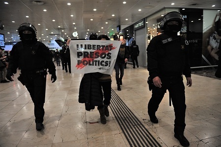 Protester with a banner being escorted by police during the demonstrations.
Around 200 radical independents tried to block the central station of Sants in the city of Barcelona on the occasion of the Resolution of the Procés Judgment. They demand freedom of Catalonia political prisoners. The autonomous police of Catalonia called Mossos de Esquadra had to evict one by one.