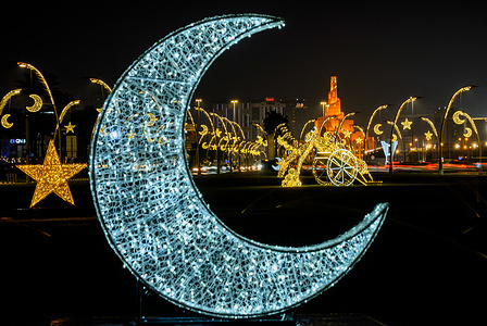 Ramadan-themed light decorations featuring crescent moon and stars illuminate a street along the Doha Corniche during the Muslim holy month of Ramadan.
