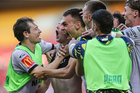 Adelaide United players seen celebrating with Brody Burkitt (shirt off) during the match between Brisbane Roar and Adelaide United at Suncorp Stadium. Final Score Adelaide United 3:2 Brisbane United