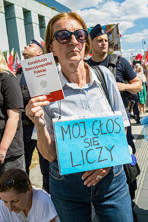 A progressive protester holds a copy of Poland's Constitution while wearing a placard that says, in Polish, "my vote counts" during the rally. On the afternoon of 1st July, following multiple appeals over the procedures of the presidential election in May, Poland's Supreme Court meet to rule on the validity of the vote won by the nationalist opposition candidate, Karol Nawrocki. The candidate nominated by the government, Warsaw's mayor, Rafal Trzaskowski trailed Nawrocki by more than 369,000 votes. Prosecutors alleged that at some polling stations, the vote count was falsified to benefit Nawrocki, which has raised a popular movement for a recount nationwide. During the court session, two protests took place outside the Supreme Court building. One protest was led by Nawrocki's supporters who demanded the court to ratify their candidate's victory, while the other, demanding a national recount, was led by the leader of the Women's Strike movement, Marta Lempart.