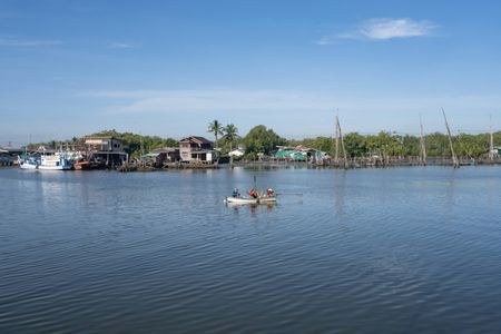 Local fishermen fishing from a small boat at the Pak Phanang River. Pak Phanang fish market in Nakhon Si Thammarat, southern Thailand, serving the local fishing community and surrounding coastal area. The market offers a glimpse of the region’s small-scale fishing industry challenged by climate change and environmental impact.