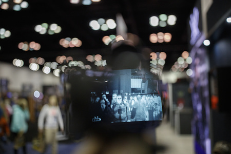 NRA convention attendees are seen through an 8000-dollar thermal scope at the Kenzie's Optics booth during the National Rifle Association's national convention. The scope is available to American civilians, but restricted for export.