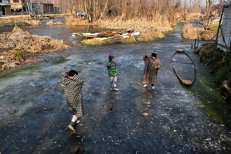 Kashmiri children walk on the frozen Dal lake on a cold day in Srinagar, Indian administered Kashmir. Severe cold wave again gripped the Kashmir Valley on Monday, the weather Office said. According to an official of the Met department the minimum temperature was minus 6.6 degree Celsius in Srinagar. The Kashmir Valley is passing through the 40-day long period of harsh winter cold known as the ‘Chillai Kalan’.