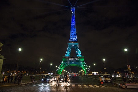 The Eiffel Tower in the colors of the new summit on the climate organized by French president Emmanuel Macron.