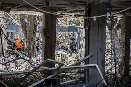 Israeli first responders seen at an impact site after an Iranian ballistic missile strike. Three regions including the coastal city were struck Sunday morning in a series of Iranian missile attacks that left at least 23 people injured according to emergency services. The strikes followed overnight U.S. attacks on key Iranian nuclear facilities including the heavily fortified sites.