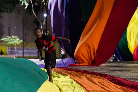 A child seen stepping on the large rainbow flag as the World LGBT Pride Day held in the city.