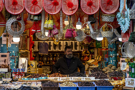 Kashmiri Muslim shopkeeper waits for customers as he sells dates and dry fruits at a local market in preparation for the holy month of Ramadan in Srinagar. Ramadan is the ninth month of the Islamic lunar calendar, during which Muslims worldwide fast from dawn to sunset, refraining from food, drink and marital intimacy as a form of spiritual reflection, prayer and charity.