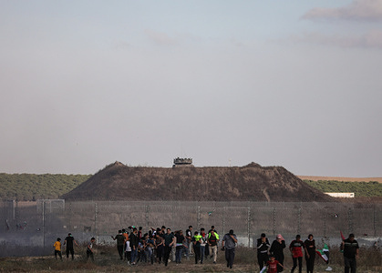 Protesters gather during a Palestinian 'flag march' along the border with Israel east of Gaza city in response to the annual Israeli flag march marking 'Jerusalem Day' commemorating the old city's capture by Israel.
