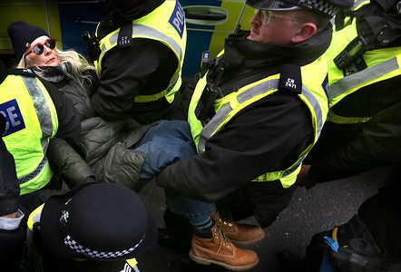 A protester is carried by police officers to waiting transport after having been arrested for holding a sign supporting a banned organisation. Protesters held signs in support of Palestine Action in defiance of the Terrorism Act outside The Ministry of Justice in London, organized by campaign group Defend Our Juries. They have planned a wave of demonstrations and protest actions to take place across the UK leading up to and during the judicial review on the proscription of Palestine Action (PA) as a terrorist group. Last month the Home Office lost an appeal to block the review, which is set to be heard November 25-27. The ban on membership or support of PA came into effect on July 5, after activists from the pro-Palestinian group broke into RAF Brize Norton and spray-painted two Voyager aircraft. Since their proscription, more than 2,000 people have been arrested for allegedly showing support for PA, mostly while holding signs reading: "I oppose genocide, I support Palestine Action." Images).