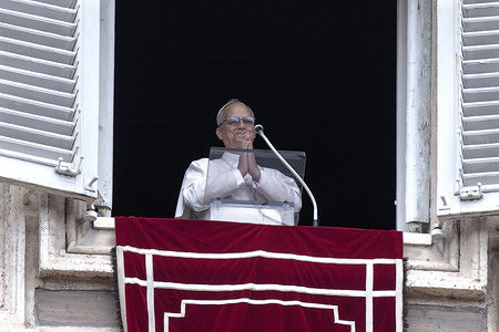 Pope Leo XIV leads the Angelus prayer from the window of the Apostolic Palace overlooking St. Peter's Square.