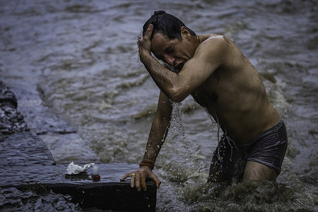 A Hindu devotee takes a holy bath in Bagmati River during the festival
During Janai Purnima, also known as the Sacred Thread festival or Rakshya Bandhan festival, Hindu men, especially the Brahmans and Chettris, perform their annual change of Janai, sacred threads worn across the chest or tied around the wrist.