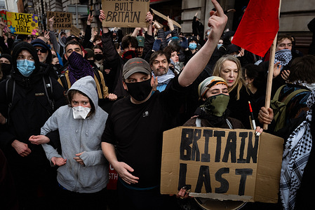 Counter protesters signal to the march. Hundreds of people gathered to counter-protest Britain First. Ex-leader of the Labour Party, Jeremy Corbyn, joined Stand Up To Racism and Trade Unions in a show of solidarity that the city will not tolerate Paul Golding's anti-migration marches.