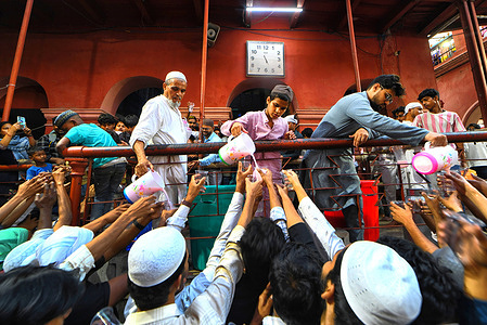 Muslims collect cold sweet water to break their fast at the Nakhoda Mosque during Ramadan. Muslims around the world are required not to eat, drink and have sexual acts from dawn to dusk during the Holy Month of Ramadan.