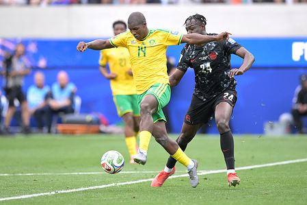 Promise David (R) of Canada men football team and Mbekezeli Mbokazi (L) of South Africa men football team seen in action during the FIFA World Cup 2026 Round of 32 match between South Africa and Canada at the Los Angeles Stadium. Final score; South Africa 0:1 Canada.