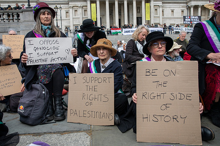 Palestine Action supporters hold placards during a demonstration in Central London. Following the Met Police’s reinstatement of its policy to take enforcement action against public expressions of support for banned organisations, members of Defend Our Juries and supporters of Palestine Action were arrested in Trafalgar Square. Around 400 demonstrators sat holding placards supporting the banned group, before officers moved in and began making arrests. The action reflected the force’s renewed approach to enforcing restrictions on public expressions of support for the banned organisation.