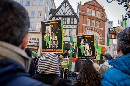 Supporters of Belfast rap group Kneecap hold up placards in defense of Mo Chara during a demonstration at his appeal at the Royal Courts of Justice. The UK Government are appealing to overthrow the September dismissal of Mo Chara’s case - the Belfast rapper is accused of displaying a flag in support of Hezbollah at a gig in London in November 2024. Hundreds of pro-Palestinian protestors were present to oppose the appeal.
