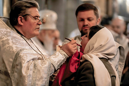 Ukrainian Orthodox priests with people attend the Good Saturday service at St. Volodymyr's Cathedral Most Ukrainians and other Orthodox Christians across Europe, Africa and the Middle East will celebrate Easter on Sunday, April 16th this year.