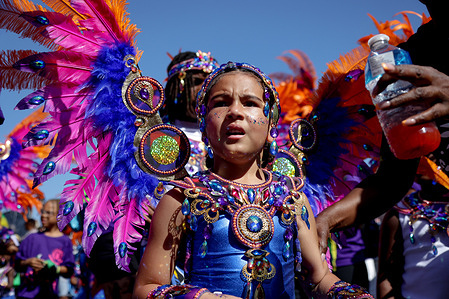 A young participant dressed in vibrant costume takes part in the parade on the first day of the Notting Hill Carnival. The Notting Hill Carnival is one of the world's largest street festivals. It is an annual Caribbean Carnival that has taken place in London since 1966 on the streets of Notting Hill over the bank holiday weekend in August.