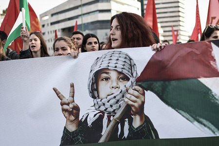 A woman seen shouting slogans while holding a large banner during a protest to demand the release of a 16-year-old Palestinian girl named Ahed Tamimi, held in Israeli military detention. The start of a military trial for the Palestinian teenager has been delayed until February 6 after a viral video showed her hitting two Israeli soldiers.
