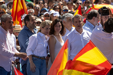 María Guardiola (L), President of the Regional Government of Extremadura, Isabel Díaz Ayuso (C), President of the Community of Madrid and Alberto Nuñez Feijoo (R), leader of the Popular Party (PP) greet their supporters during the rally. A rally is held in Plaza de España organized by the Spanish Popular Party (PP) against the government of Socialist Pedro Sánchez under the slogan "Mafia or democracy."