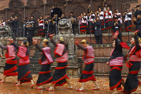 Women clad in traditional attire sing and dance on the first day of Indra Jatra at Hanuman Dhoka Durbar Square. Indra Jātrā is the biggest religious festival in Nepal's Kathmandu Valley. Indra Jātrā is celebrated with masked dances of deities and demons alongside displays of sacred images in honor of the deity Indra, the king of heaven.Indra Jatra, or Lord Indra, is the Hindu king of the heavens
