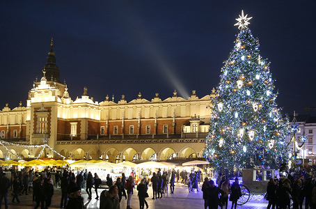 Christmas tree seen on the Main Square with in the background the Cloth Hall (Sukiennice).
Christmas illuminations appeared in Krakow and the Christmas market began as thousands of lights shine every night on the main streets and squares of the city. Most decorations were prepared for the old town, also on the Main Square, a huge Christmas tree has been set.