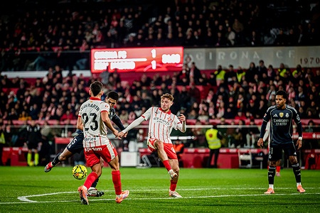 Jude Bellingham (Real Madrid CF) and Iván Martín (Girona FC) seen in action during the La Liga EA Sports match between Girona FC and Real Madrid at Estadi Municipal de Montilivi. Final score: Girona FC 1 - 1 Real Madrid.