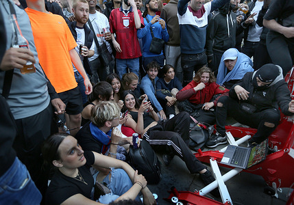 Fans gather watching the England Denmark match on a laptop in the street.
After 55 years without a major football trophy England fans watch the euro 2020 semi-final final match between England and Denmark at Wembley. After a 2-1 win they move on to the final against Italy.