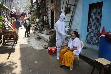 A healthcare worker wearing a personal protective equipment suit (PPE) collects a swab sample from a woman residing in a slum colony at Dharavi.
Corona virus cases have been rising in Maharashtra state after the lockdown. People have been advised not to gather in large numbers in public places, maintain social distance, wear mask and sanitize their hands regularly.