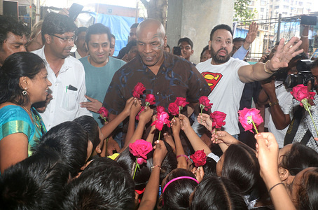 Former American professional boxer Mike Tyson seen receiving flowers from kids during his visit at Dharavi slum.
Mike Tyson came to Mumbai to support Kumite 1 League, Indias first global Mixed Martial Arts (MMA) league.