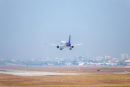 Thai Smile Airways airplane landing at Chiang Mai International Airport (CNX).amid dense blanket of smog in Chiang Mai. Air pollution is a problem that generally affects northern Thailand. The pollution leads to an increase in health issues among the local population.