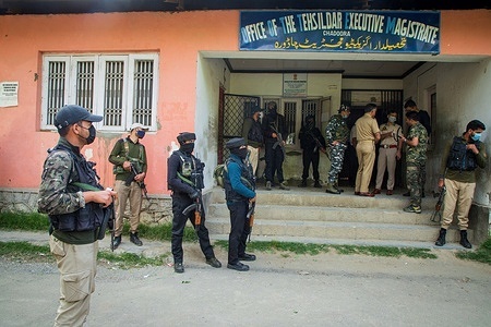Indian Policemen and Paramilitary troopers stand on guard outside a government office in the Chadoora area of central Kashmir's Budgam district where an employee from the Kashmiri Pandit community was shot dead by militants. This attack comes a day after two separate encounters in Bandipora and Anantnag districts in the disputed region.