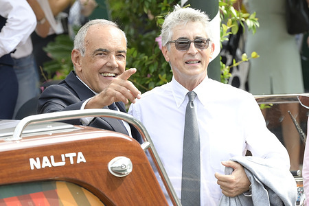 Alberto Barbera (l) and Alexander Pyne (r) arrive at Hotel Excelsior dock at Venice Lido for 82 Venice Film Festival.