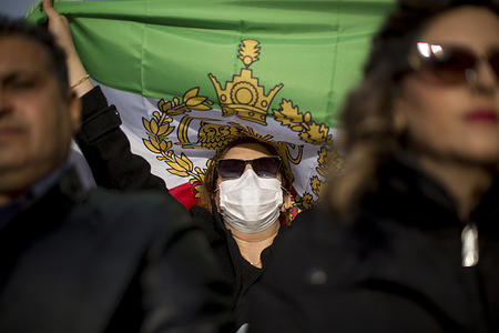 Member of the Iranian community living in Madrid waves an Iranian flag during a demonstration in Plaza de Cibeles, to denounce the intensification of the Islamic State's repression against the Iranian population in recent weeks.