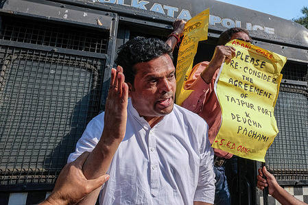 Congress workers hold placards during a protest against the state government for their investment agreement of Tajpur port & Deucha Pachami coal mines with the Adani group.
