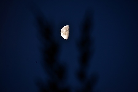A view of Venus and The Waning Gibbous moon seen together in a clear morning sky in Srinagar, Kashmir.