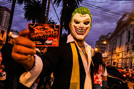 A person is seen dressed as the Joker during the Halloween celebration in Valparaiso.