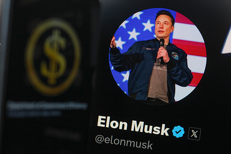 In this photo illustration, Elon Musk's official profile on the X social network is seen displayed on a smartphone screen and the Department of Government Efficiency (DOGE) logo in the background. Elon Musk's official profile on the X social network