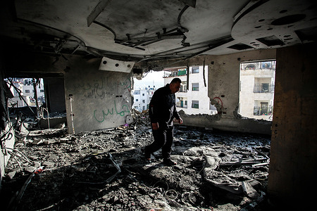 A Palestinian inspects the apartment of Khaled Kharousha that was damaged by the Israeli military. Israel's High Court of Justice gave the army the go-ahead to destroy Kharousha's apartment, who is suspected of helping his father to kill two Israelis in Huwara earlier this year.