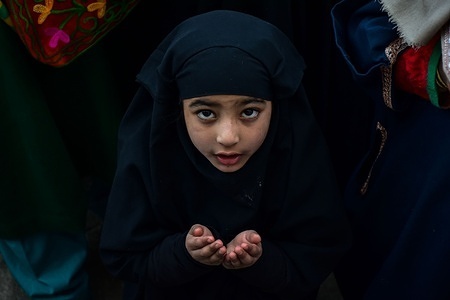 A Kashmiri Muslim devotee prays during the last Friday of Lailat al Miraj or Mehraj-u-Alam, which marks ascension day, the journey from earth to heavens of the Prophet Muhammad (PBUH) at the Hazratbal Shrine.