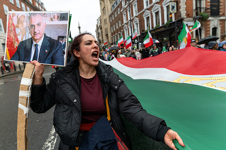 A woman chants slogans while holding a portrait of Shah Reza Pahlavi. Members of the Iranian diaspora marched through central London from Marble Arch to Downing Street in protest against the Iranian government, calling for an end to repression and political violence in Iran. Demonstrators carried Iranian flags, chanted anti-government slogans and urged the UK and international community to take a firmer stance in support of human rights and democratic change.