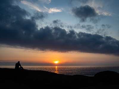 A pilgrim is seen watching the sunset. After reaching the cathedral of Santiago de Compostela, there is a bonus to the pilgrimage that guides walkers northwards up the coast to the Santuario de Nuestra Señora de la Barca in Muxía, 29km north of the “end of the world” itself.
