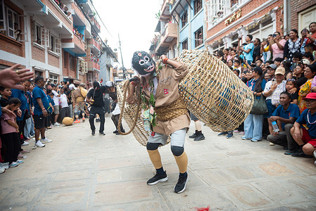 A man dressed in a traditional costume performs a holy dance during the festival. People celebrate Gai Jatra or cow festival in memory of the departed souls in the past year for salvation and peace. It is believed that cows guide the departed souls to cross the river to get to heaven.