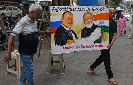Teachers from Gurukul school of art carry back a poster of Russian President Vladimir Putin and Indian Prime Minister Narendra Modi outside their art school in Mumbai. Russian President Vladimir Putin will be on a two day visit to India for the 23rd India-Russia summit. Indian Prime Minister Narendra Modi and Russian President Vladimir Putin will exchange views on regional and global issues affecting both the countries.