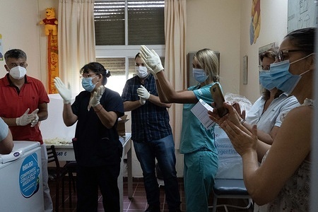 San Martin Hospital healthcare personnel wearing face masks are seen applauding after receiving 200 COVID-19 vaccines.
The sputnik vaccines are to be received first by the first line COVID-19 healthcare workers, and it’s the beginning of the COVID-19 vaccination campaign announced by President Alberto Fernandez.