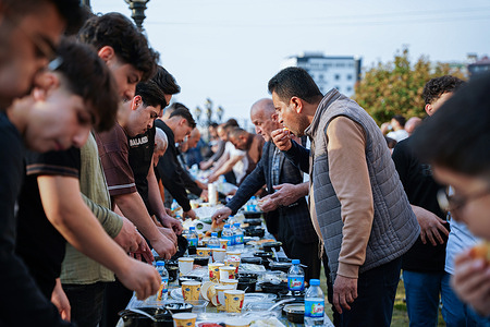 Iraqi Kurdish Muslims eat breakfast in the courtyard of Saido mosque after Eid al-Fitr prayers in the city of Dohuk in the Kurdistan Region of Iraq. Eid al-Fitr marks the end of the Muslim holy fasting month of Ramadan.