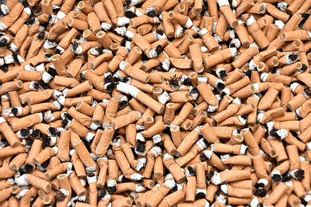 In this photo illustration, cigarette butts are seen in a pile.