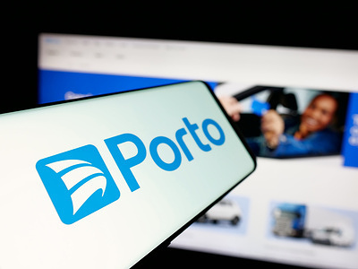 In this photo illustration, a smartphone with the logo of Brazilian insurance company Porto Seguro S.A. is seen on screen in front of website.