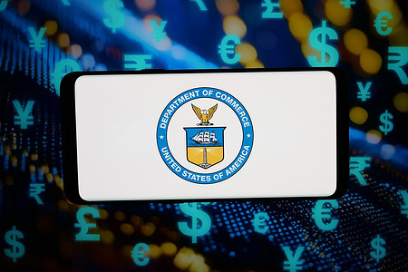 In this photo illustration, the United States Department of Commerce (DOC) logo is seen displayed on a smartphone in front of abstract background on computer screen.